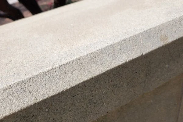 A light concrete ledge has a clean and even surface.