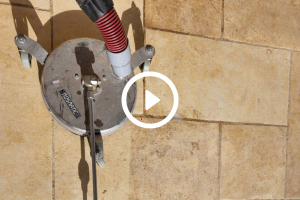 Pressure washing tile floor with a round surface cleaner, showing the Rosmatic brand. Cleaning grout and tile to improve home appearance.