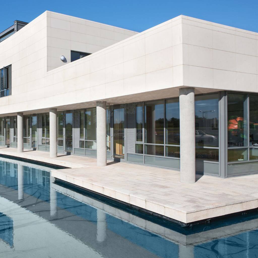Modern building with large windows reflecting a pool in Lubbock, Texas. Atlas Scrubbed offers window cleaning services for homes and businesses.