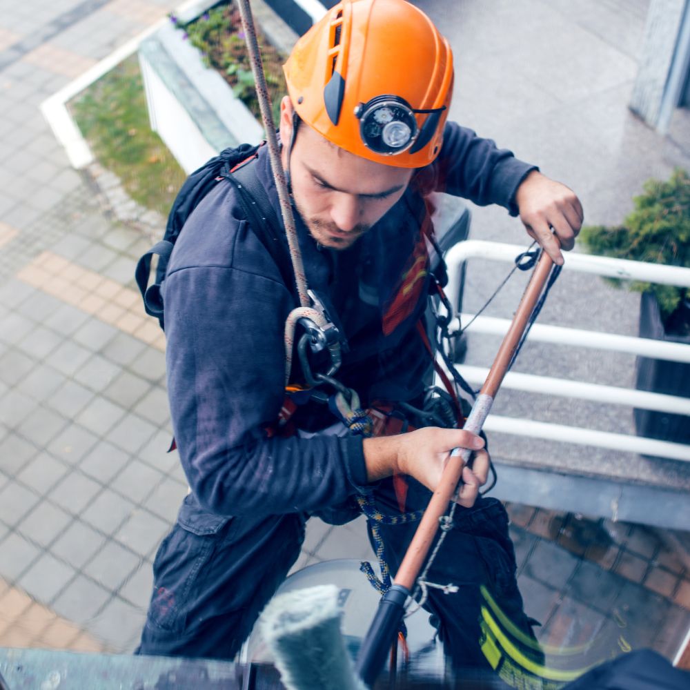 Rope access window cleaner in McCamey, Texas providing professional commercial window cleaning.